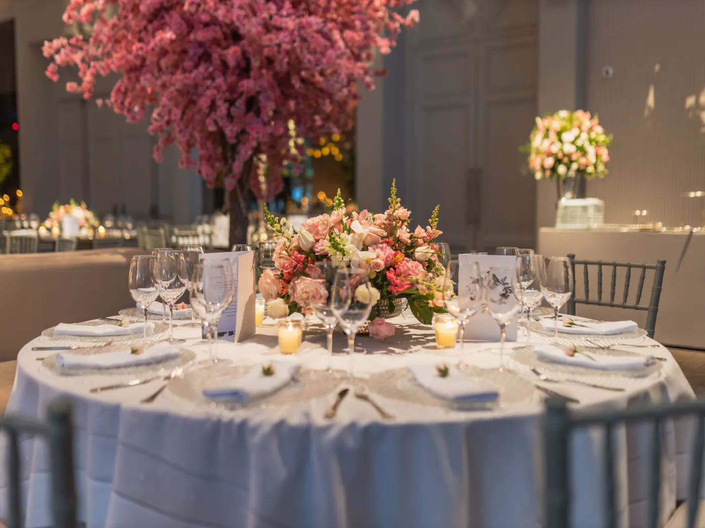 Celebration dining table with warm lighting and place settings.