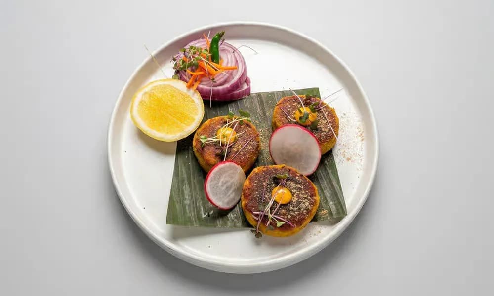 Bhutte Ke Kebab arranged on a light ceramic plate.