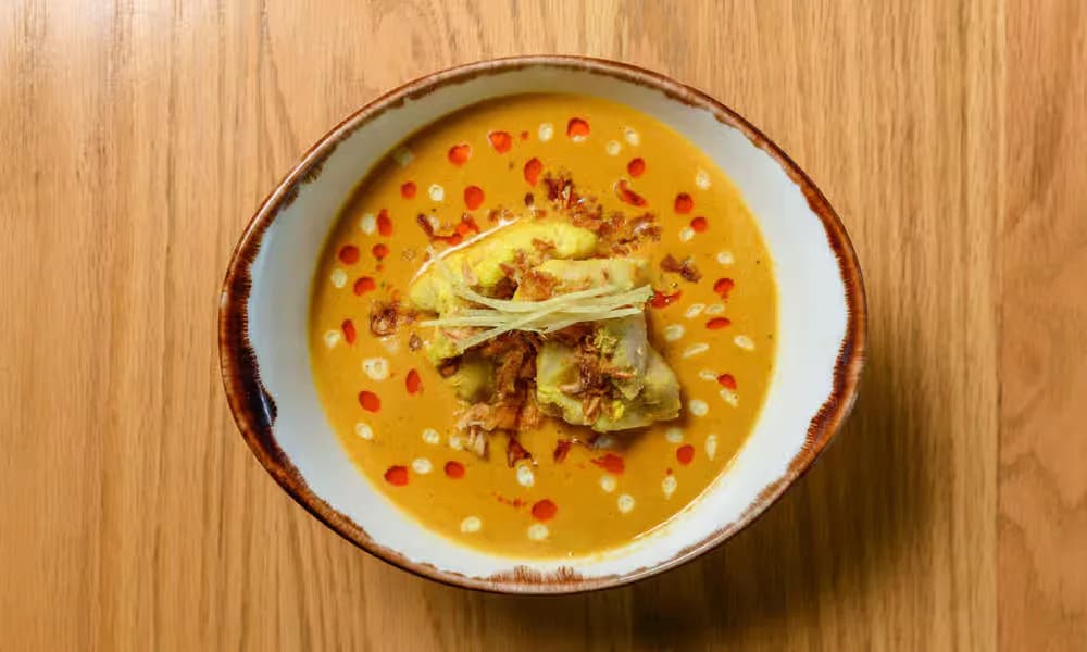 Chicken Korma served in a light ceramic bowl.