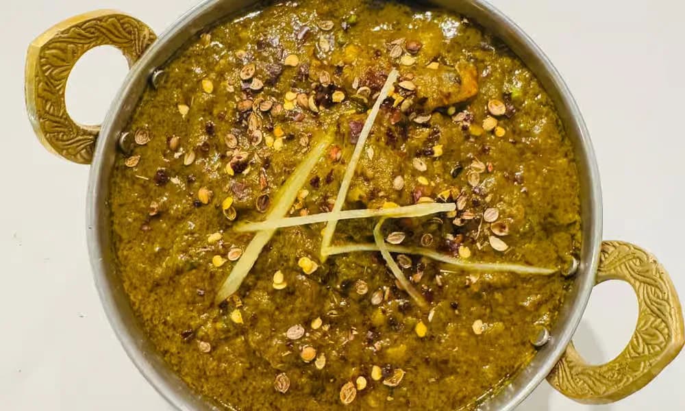 Coriander Prawns served in a handled metal bowl.