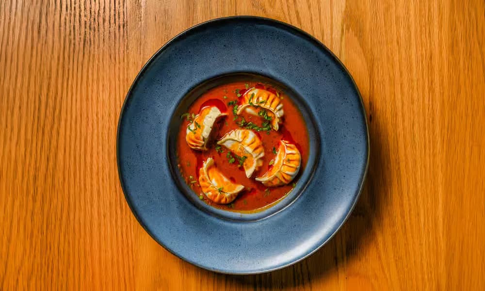 Jhol Momo served in a spiced broth.
