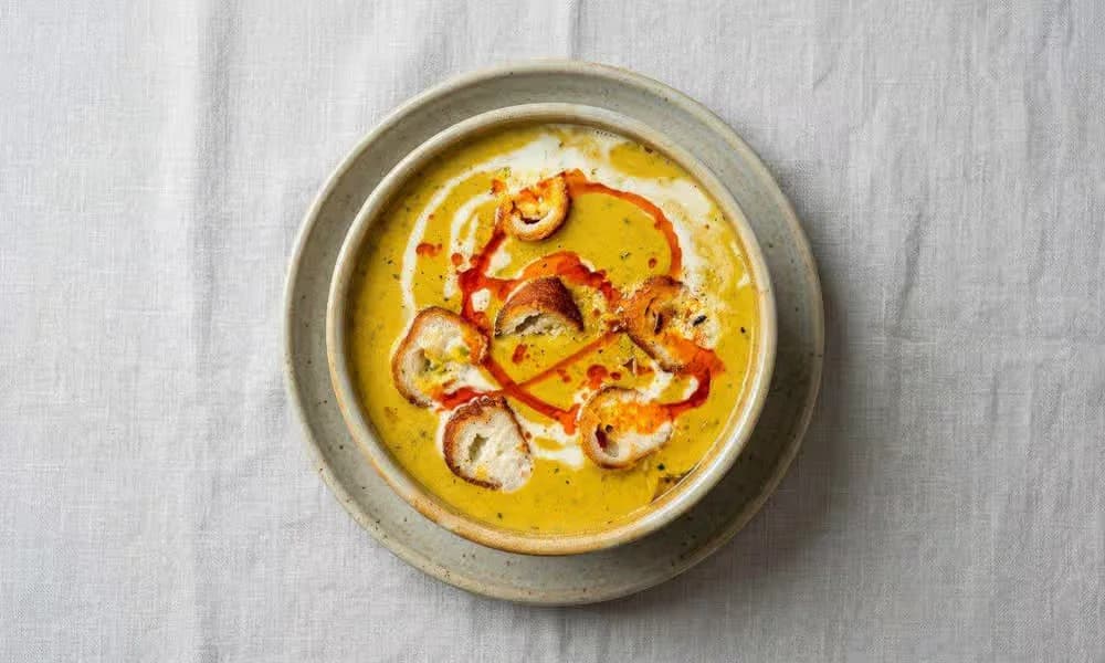 Malai Kofta served in a light ceramic bowl.