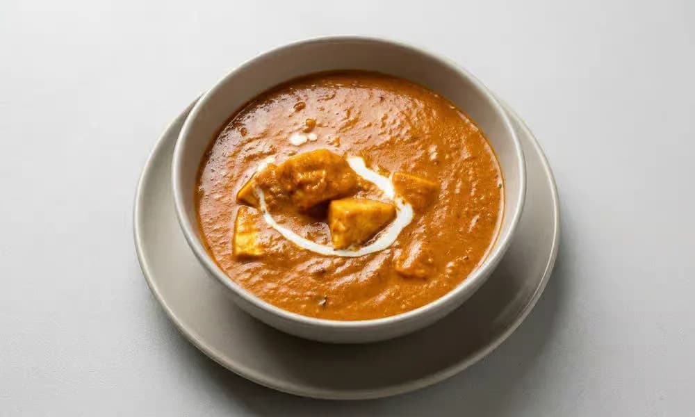 Paneer Tikka Masala served in a shallow metal bowl.