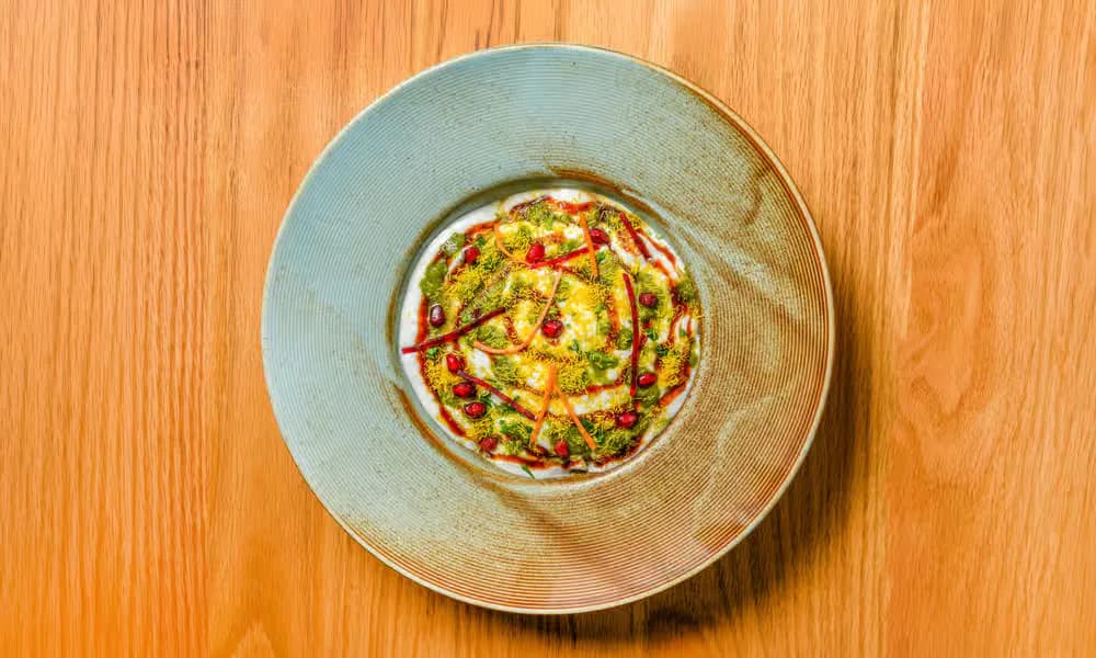 Papdi Chaat presented in a shallow ceramic bowl.