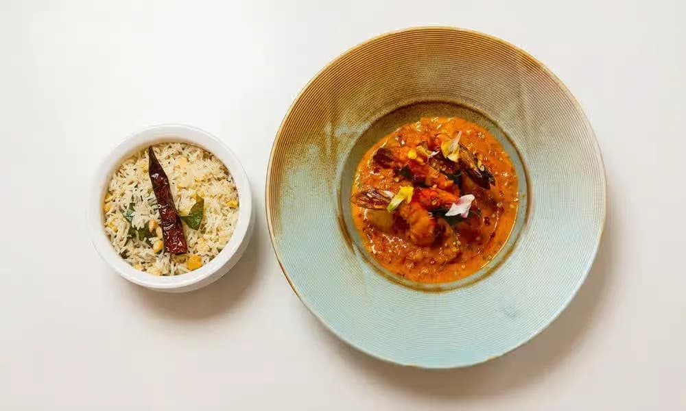 Prawn Mango Curry served in a light ceramic bowl.