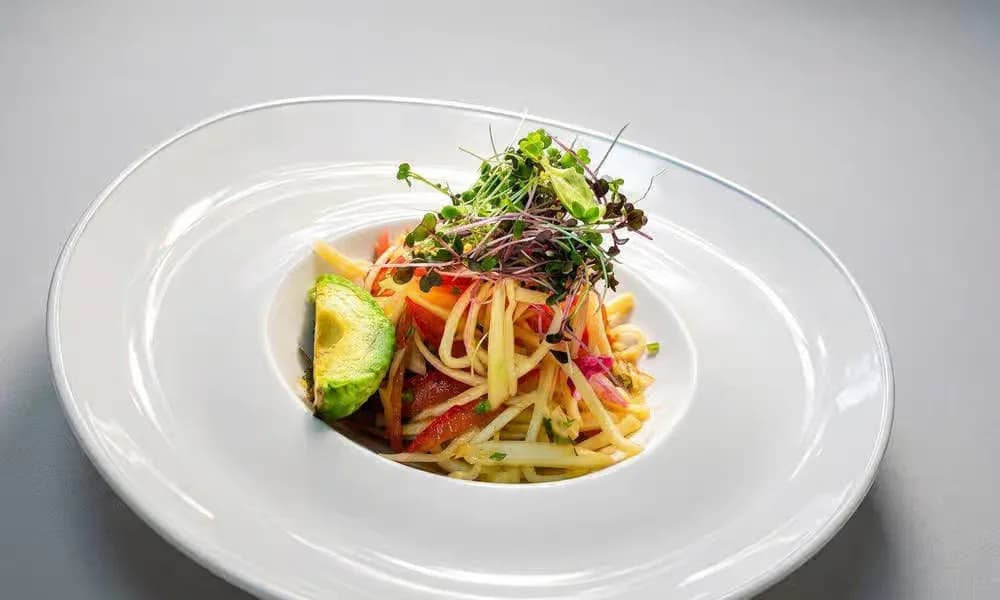 Raw Mango Salad presented on a white plate.