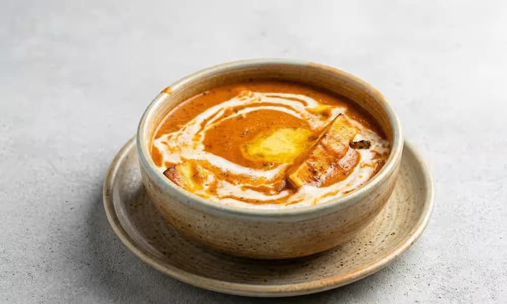 Tandoori Paneer Makhani served in a neutral ceramic bowl.