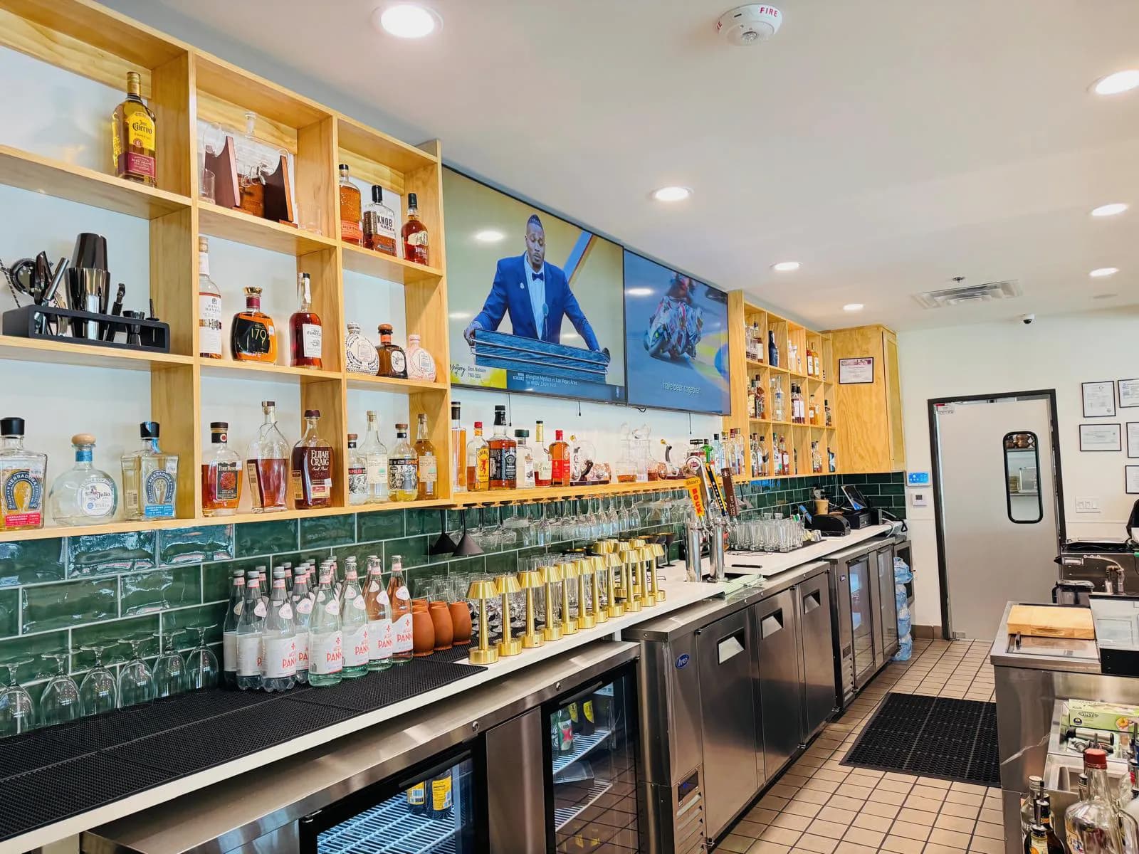 Namak bar shelving, draft taps, glassware, and stainless service counter.