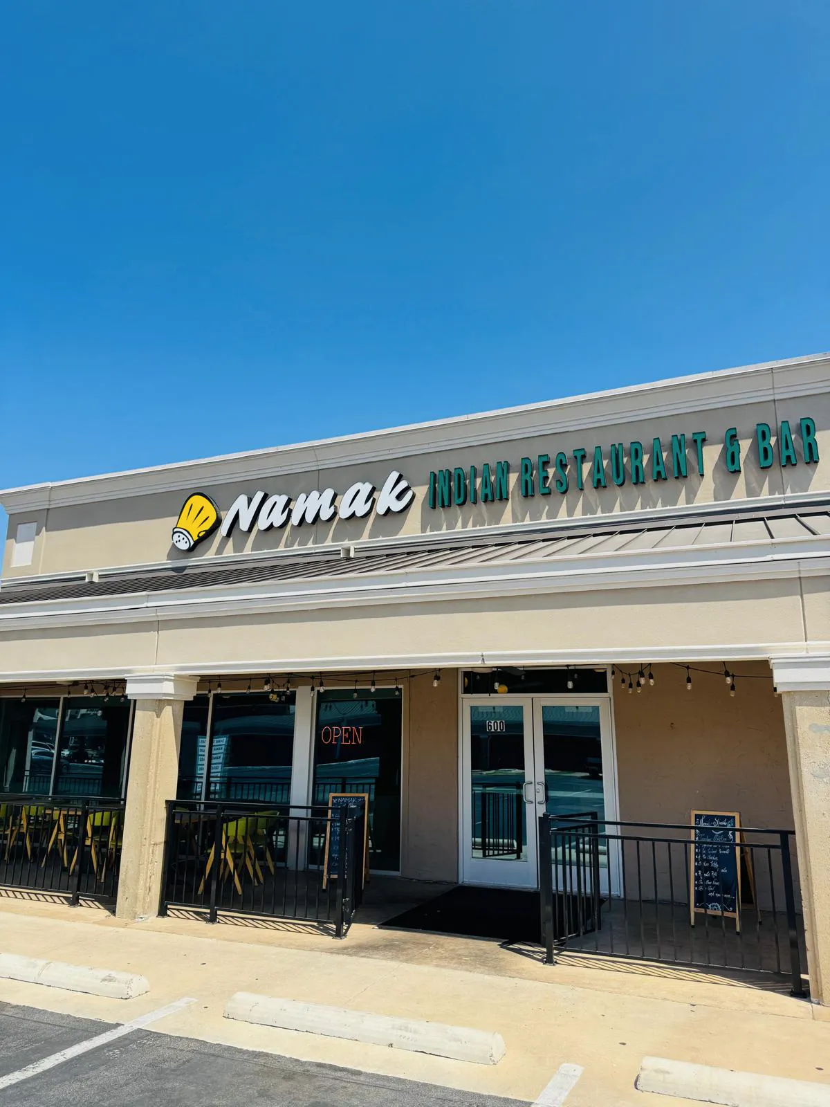 Front entrance and Namak signage viewed from the Greenville Avenue parking area.